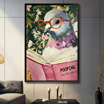 Funny pigeon wearing orange glasses reading Pooping on People pink book framed wall art print displayed in a living room with gray sofa, pillar candle holders, and black decorative vase against dark gray tiled wall