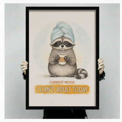 Hands holding a large black framed funny raccoon with towel and coffee I Can't Adult Today canvas art print with a chubby gray raccoon wearing a blue twisted towel turban clutching a steaming coffee cup with a weary deadpan face above a bold golden yellow I Can't Adult Today quote banner on a soft off-white background
