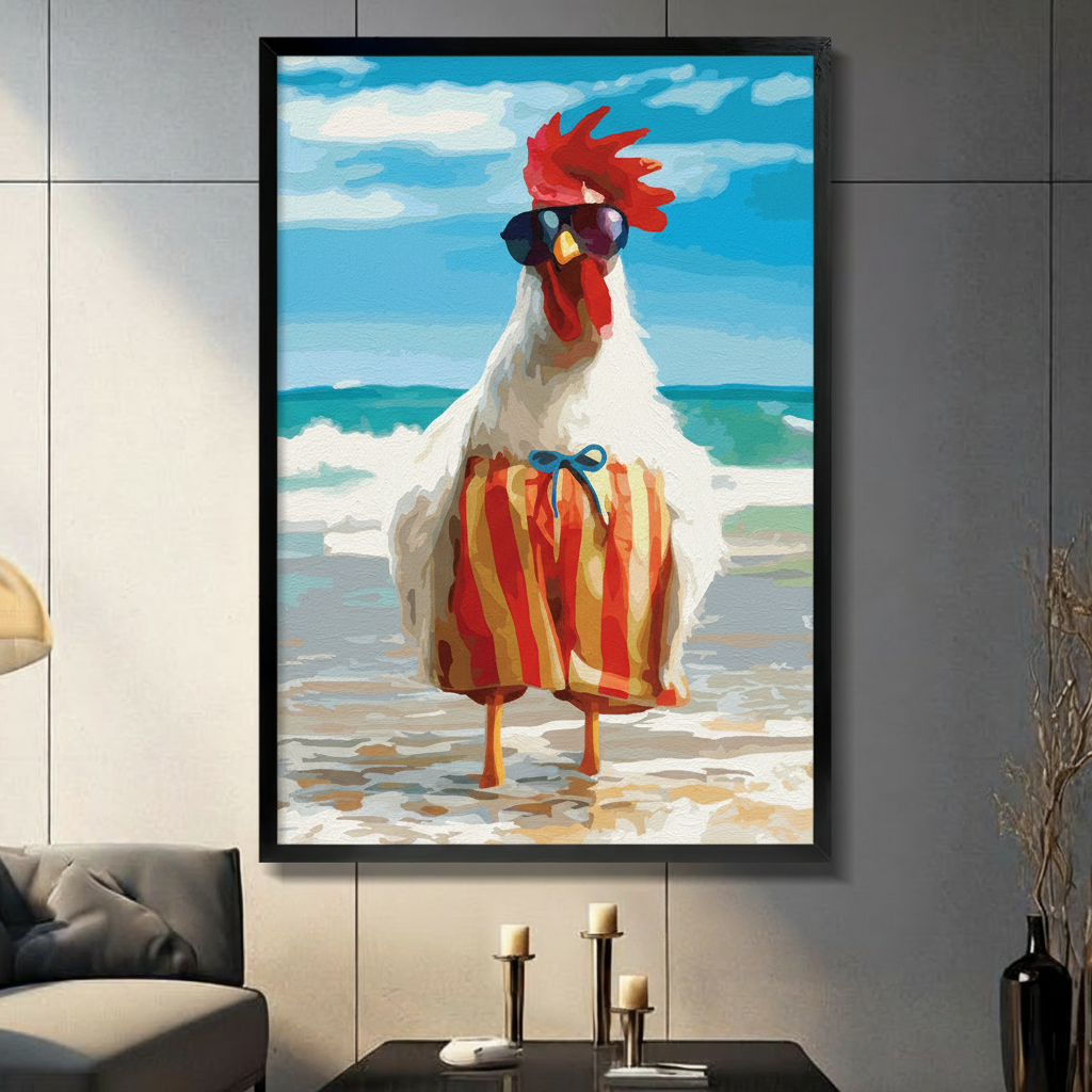 Black framed funny rooster on beach with sunglasses and striped shorts canvas art with a confident white rooster wearing dark sunglasses and red-yellow striped swim trunks standing on a sandy beach with turquoise ocean waves behind it, hung on a gray panel wall above a dark gray sofa