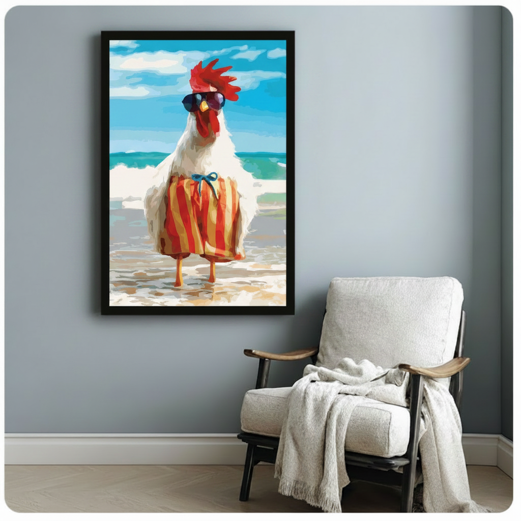 Black framed funny rooster on beach with sunglasses and striped shorts canvas art showing a cool white rooster with dark sunglasses and red-yellow striped swim trunks posed on a sandy beach with bright turquoise ocean waves, displayed beside a white linen armchair with a cream throw