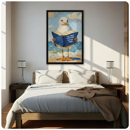 Funny YOLO seagull reading book framed wall art above a dark wood bed with white linen bedding, a taupe throw blanket, and matching white bedside lamps in a sunlit modern bedroom