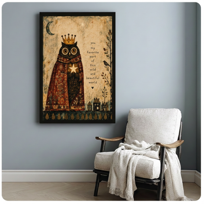 Vintage crowned owl canvas wall art in a black frame beside a cream armchair against a gray wall.