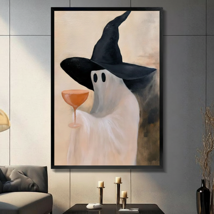Ghost in black witch hat holding orange coupe glass, black float frame canvas art on dark gray tile wall above console table with gold candlesticks