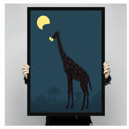 Person holding a black framed canvas print of a giraffe eating the moon at night, showing actual print size against a neutral background
