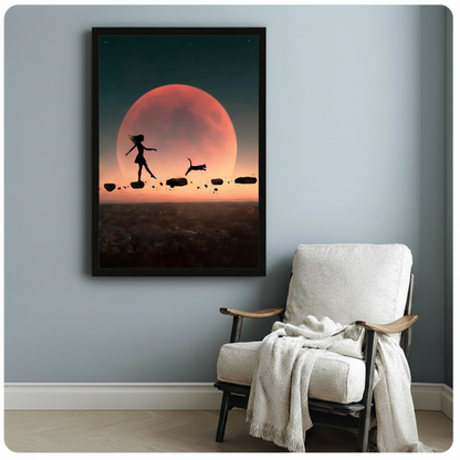 Black framed girl and cat red moon silhouette art print hanging on a light grey wall beside a linen armchair with a draped blanket