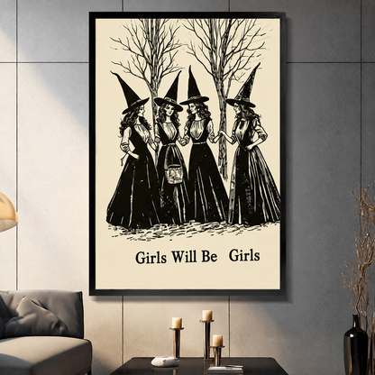 Framed gothic wall art print of four witches in black dresses with pointed hats standing among bare trees, titled Girls Will Be Girls, displayed in a modern living room above a dark coffee table with candles