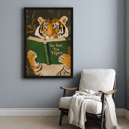 Framed tiger reading book wall art in black frame above armchair in a cozy reading nook