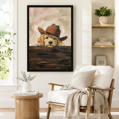 Black framed impasto oil painting of a curious golden doodle puppy in a cowboy hat styled beside a linen armchair in a bright Scandinavian reading nook