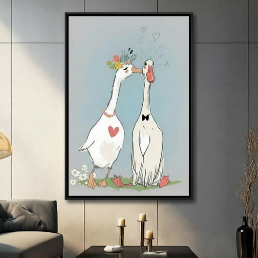 Romantic goose couple wall art print with floral crown and bow tie, illustrated in soft blue tones, displayed in black frame on dark grey wall