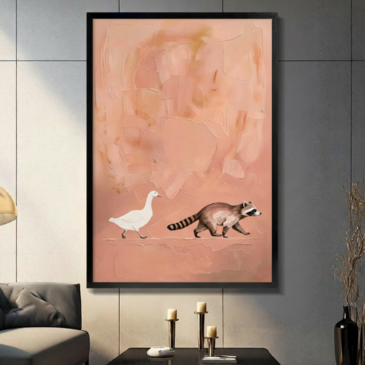 Black framed minimalist white goose and raccoon walking together on a warm coral pink impasto textured abstract background with palette knife crackle marks naive art canvas wall art displayed in a modern gray living room with dark sofa black coffee table and metal candlestick holders