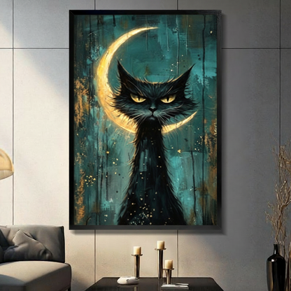 Black framed gothic black cat with crescent moon canvas art with an intense brooding black cat with piercing golden yellow eyes and wild spiky fur set against a glowing golden crescent moon on a moody teal and dark gold drip-painted background with scattered gold star flecks, hung on a gray tiled wall above a dark gray sofa
