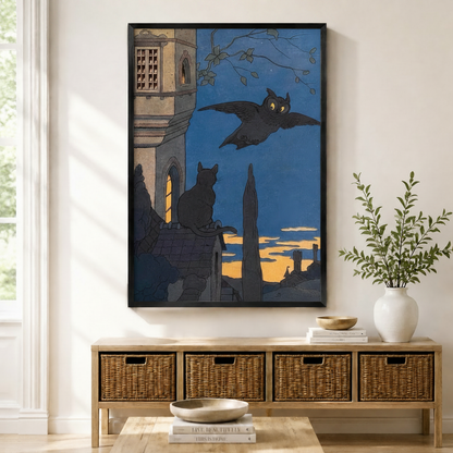 Gothic vintage owl and black cat night scene art print in black frame displayed above wicker console table in neutral entryway
