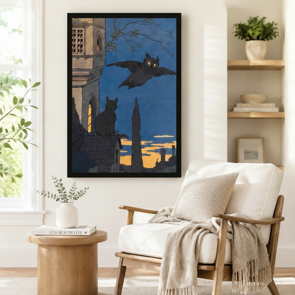 Black framed gothic owl and black cat at dusk vintage wall art print beside linen armchair in cozy minimalist reading corner