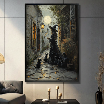 Gothic witch with black cats moonlit alley framed canvas art on a dark gray wall above candlesticks in a moody modern living room