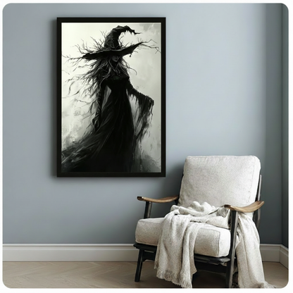 Black framed atmospheric gothic witch portrait with a crumbling wide-brim hat sprouting bare twisted branches long dark hair tangled with twigs and a shredded black cloak caught in the wind dark fantasy monochrome oil painting canvas print on misty gray background hung on a soft blue-gray wall beside a white linen armchair with cream throw
