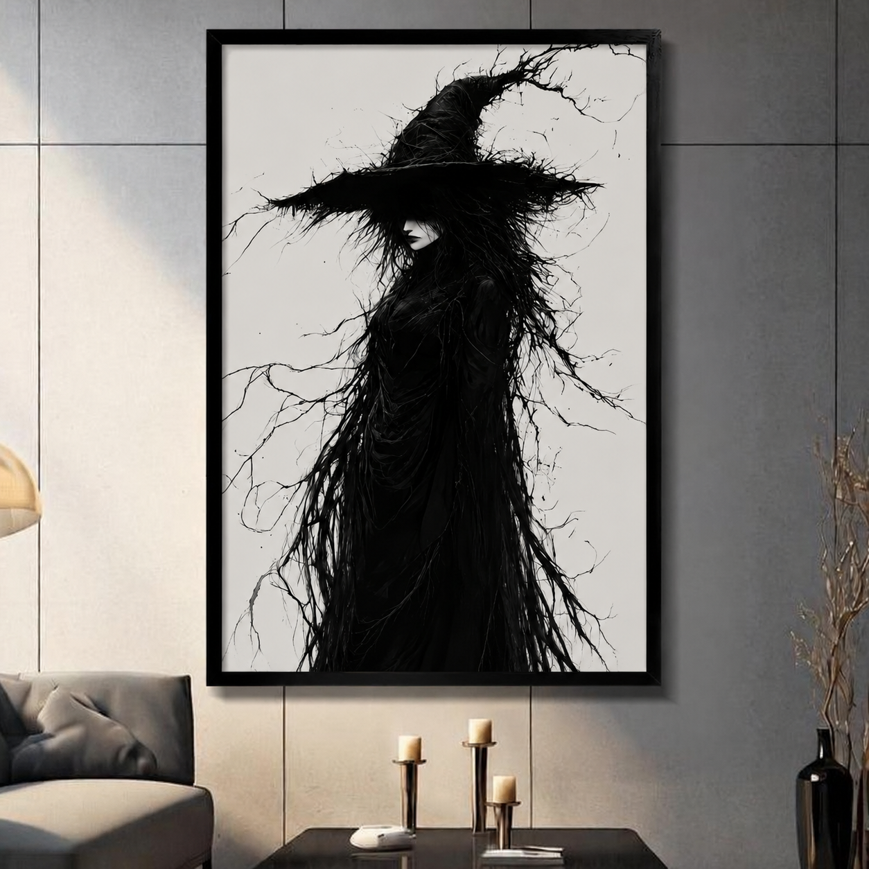 Framed gothic wall art print of a mysterious witch figure in a wide-brimmed hat with dark tangled branches and flowing black hair, displayed in a modern living room above a console table with candles