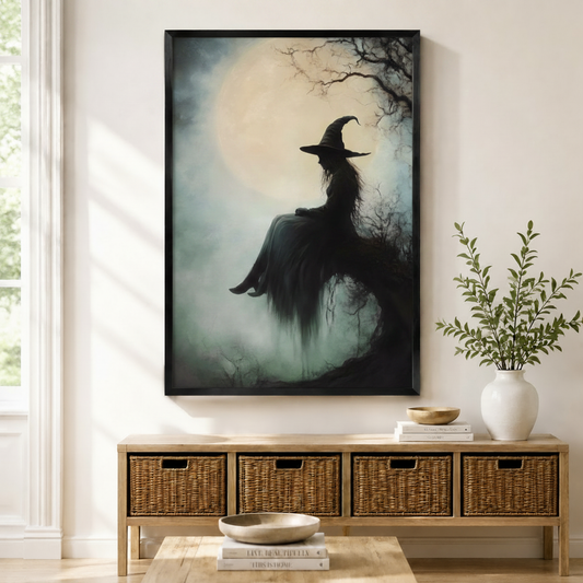 Gothic witch silhouette seated under full moon misty forest oil painting art print in black frame above wicker console in neutral entryway