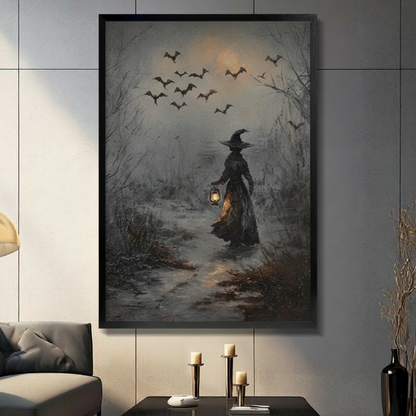 Gothic witch with lantern walking through dark forest framed wall art print displayed in a moody living room with black sofa, candle holders, and decorative vase
