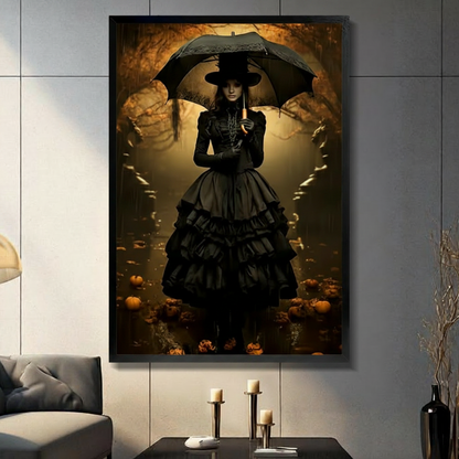 Dark academia gothic witch in Victorian black ruffled gown and wide-brim hat holding lace umbrella in golden amber autumn forest with scattered pumpkins framed wall art print displayed in a moody living room with gray sofa, pillar candle holders, and black decorative vase