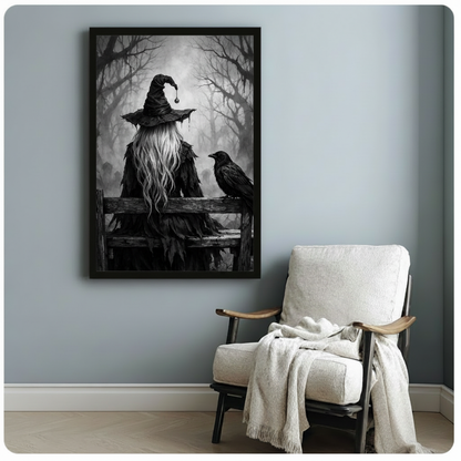 Moody gothic dark art painting of a witch viewed from behind wearing a tattered black wide-brim hat with a black bead pendant and a ragged feathered dark cloak with long flowing silver hair seated on a weathered fence rail beside a large black raven looking back at her in a haunting mist-shrouded forest of bare branches dramatic black and white witch wall art framed print beside a white linen armchair on a blue-gray wall