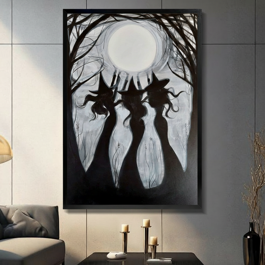 Black framed gothic three witches full moon canvas wall art in black and white displayed in a moody dark gray living room with candlesticks and tall black decorative vase