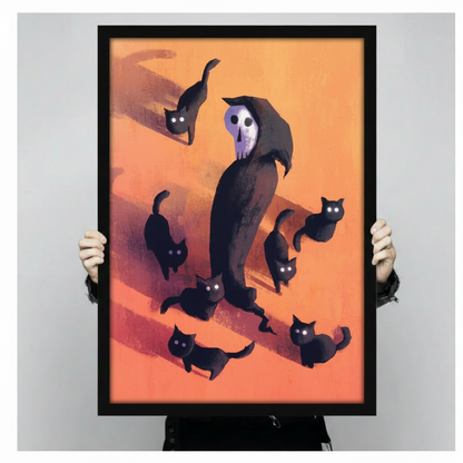 Hand-held framed wall art print showing a dark skull-faced reaper in a black cloak encircled by seven black cats with glowing eyes on a warm orange background
