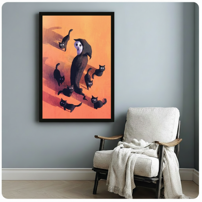 Vertical framed canvas of a hooded grim reaper skull surrounded by playful black cats on an orange background, hung on a blue-grey wall beside a white linen armchair