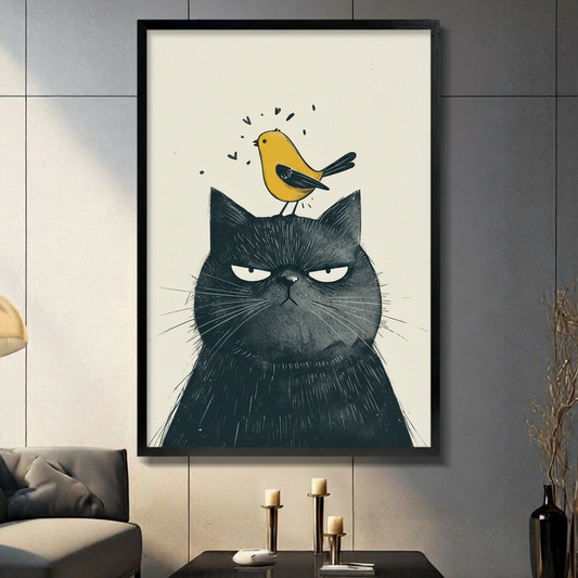 Framed canvas wall art of a grumpy black cat with a cheerful yellow bird perched on its head, whimsical illustration style, displayed in dark modern living room