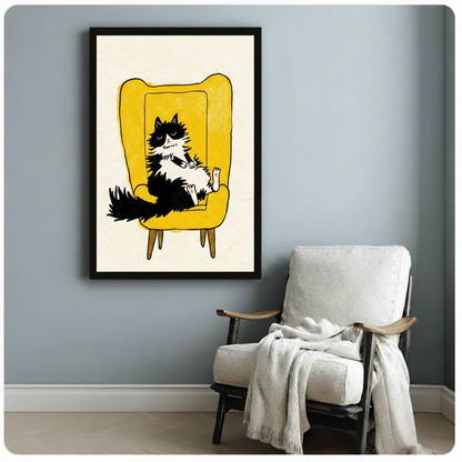 Funny cat canvas print in black frame on blue-grey wall beside white armchair