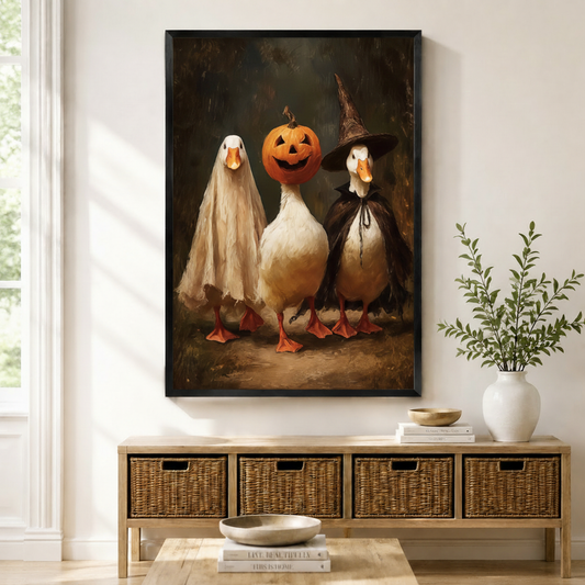 Whimsical Halloween duck trio framed canvas wall art above rattan bench — ghost pumpkin witch duck oil painting