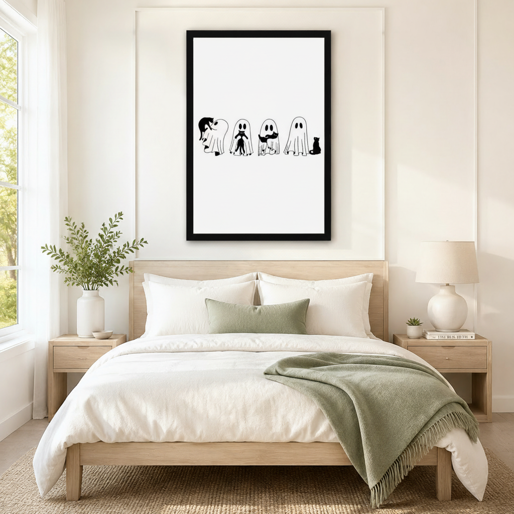 Oversized black-framed canvas of four cute ghosts and black cats in minimalist line art, mounted as a Halloween statement piece above a neutral linen bed in a serene Scandinavian bedroom