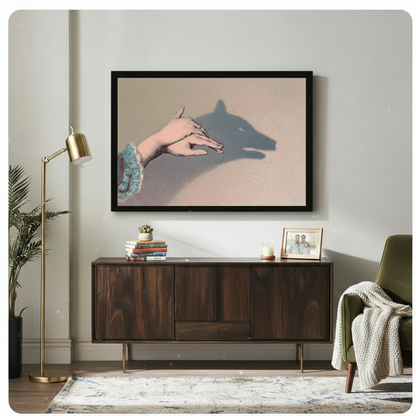 Framed hand shadow wolf wall art displayed above a dark wood sideboard in an eclectic living room with brass floor lamp and green armchair