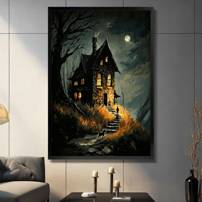 Framed dark gothic wall art print of a glowing stone haunted house on a moonlit night with bare trees, a silhouetted figure on stone steps, and a black cat, displayed above a console table in a modern living room