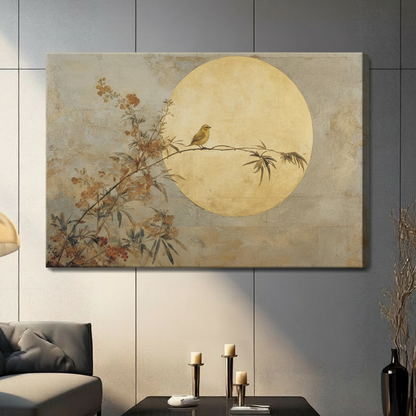 Gallery-wrapped stretched canvas of solitary bird perched on flowering branch before full golden moon in warm beige and amber tones hung on gray panel wall