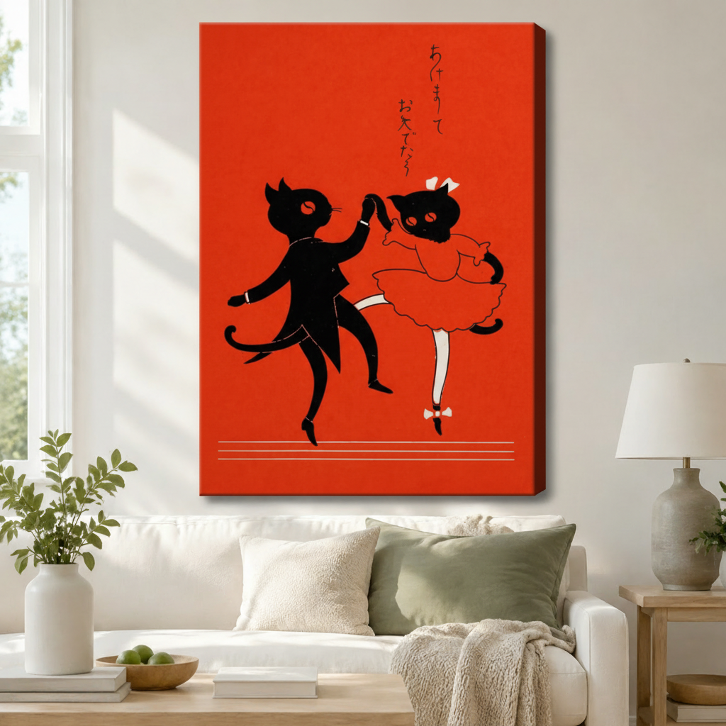 Stretched canvas wall art of a vintage Japanese black cat couple dancing on a bold red background, displayed above a white sofa with sage green cushions and a ceramic table lamp