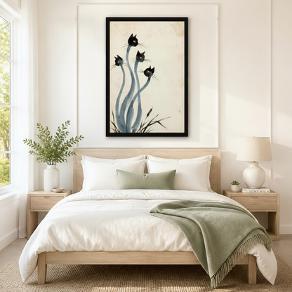 Black framed Japanese ink style black cats canvas art with four surreal black cat heads with golden eyes on long sinuous blue-gray stems above brushed ink grass on an aged parchment background, hung above a light wood bed with white linen bedding and a sage green throw in a serene Scandinavian bedroom