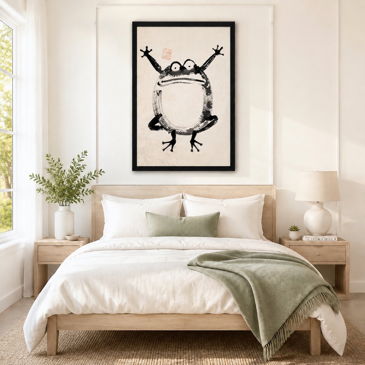 Large black-framed Japanese ink wash frog art print hung above a natural wood bed frame in a serene Scandinavian-style bedroom