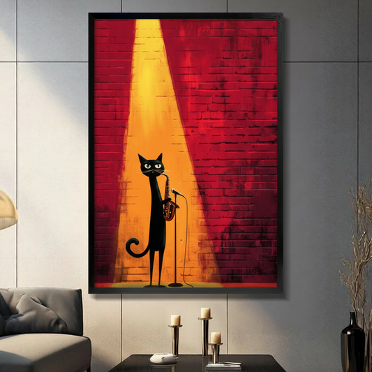 Black framed jazz black cat playing saxophone on stage canvas art with a sleek elongated black cat with glowing yellow-green eyes playing a golden saxophone while standing at a microphone stand bathed in a dramatic warm golden yellow spotlight beam against a deep red textured brick wall background, hung on a gray panel wall above a dark gray sofa