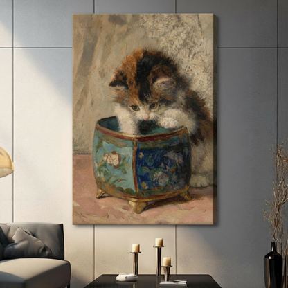 Gallery wrap stretched canvas of a fluffy calico kitten with black orange and white fur leaning over a blue and gold chinoiserie porcelain pot hung frameless on a gray marble wall above a dark sofa with candlesticks
