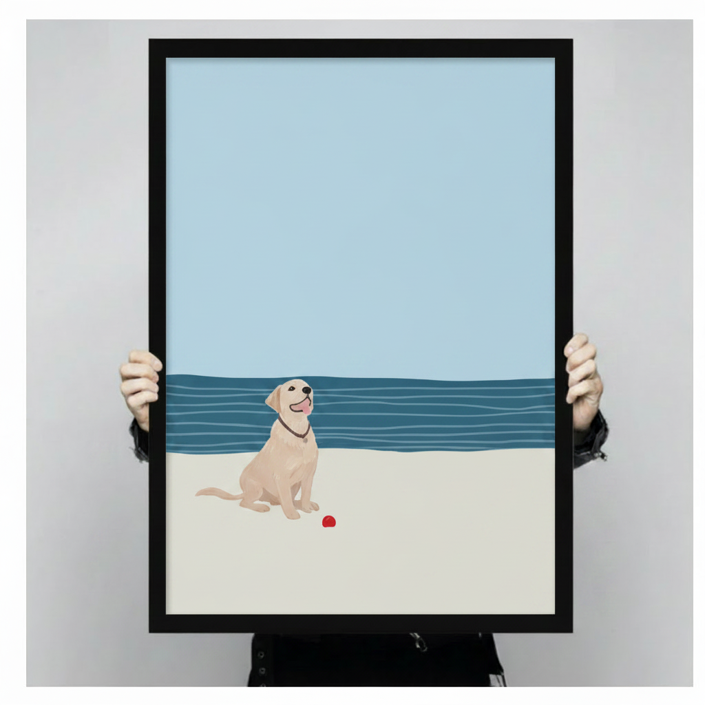 Hand-held black framed canvas print of happy yellow labrador sitting on sandy beach with red ball
