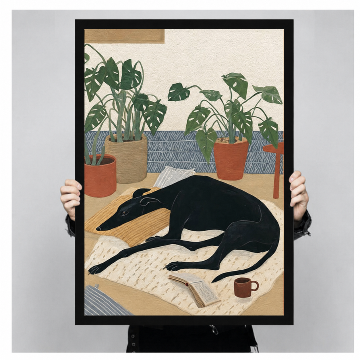 Large black greyhound art print with black frame held up for size reference, whimsical dog monstera illustration poster