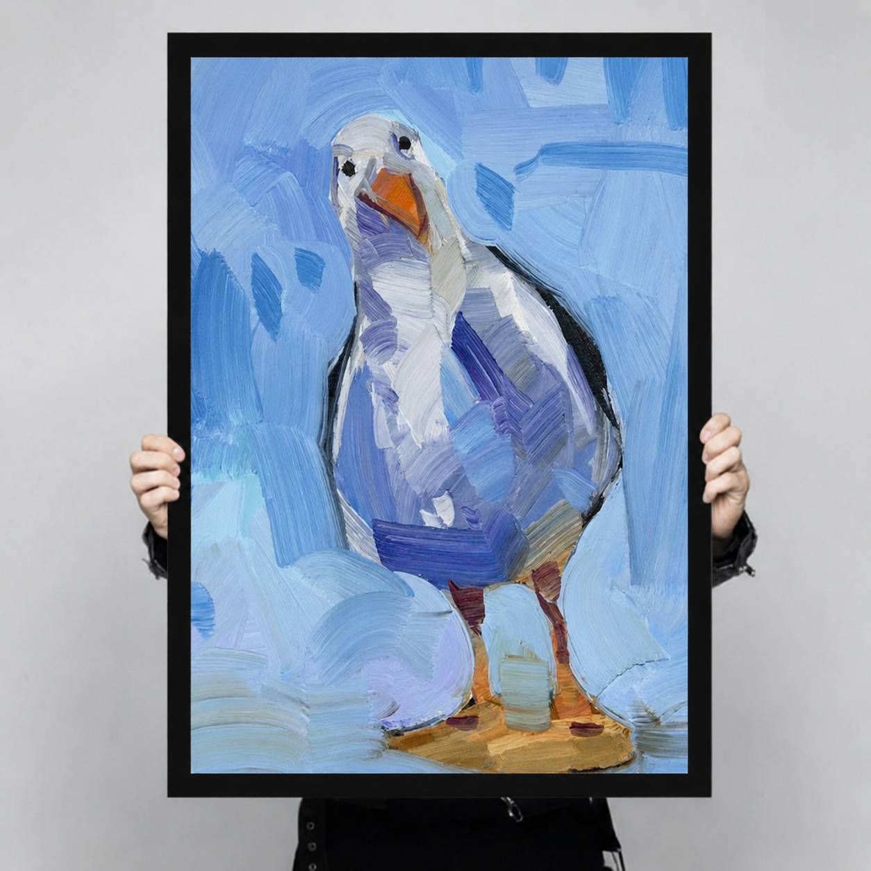 Large seagull oil painting art print with black frame held up for size reference, thick brushstroke coastal bird decor