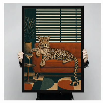 Stylish leopard lounging on rust orange retro couch with martini cocktail glass on round side table in front of deep teal wall with venetian window blinds and palm plant abstract geometric color block rug mid-century modern animal illustration framed wall art print held up for size reference against a light gray neutral background
