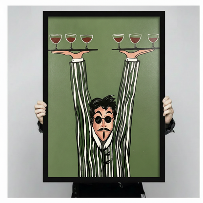 Bold graphic cartoon illustration of a wide-eyed waiter with black round sunglasses a goatee and an open-mouthed expression wearing an olive green and white striped suit with impossibly long arms raised high holding two black trays each with three red wine glasses on a flat olive green background quirky waiter wall art framed print held against a light gray background
