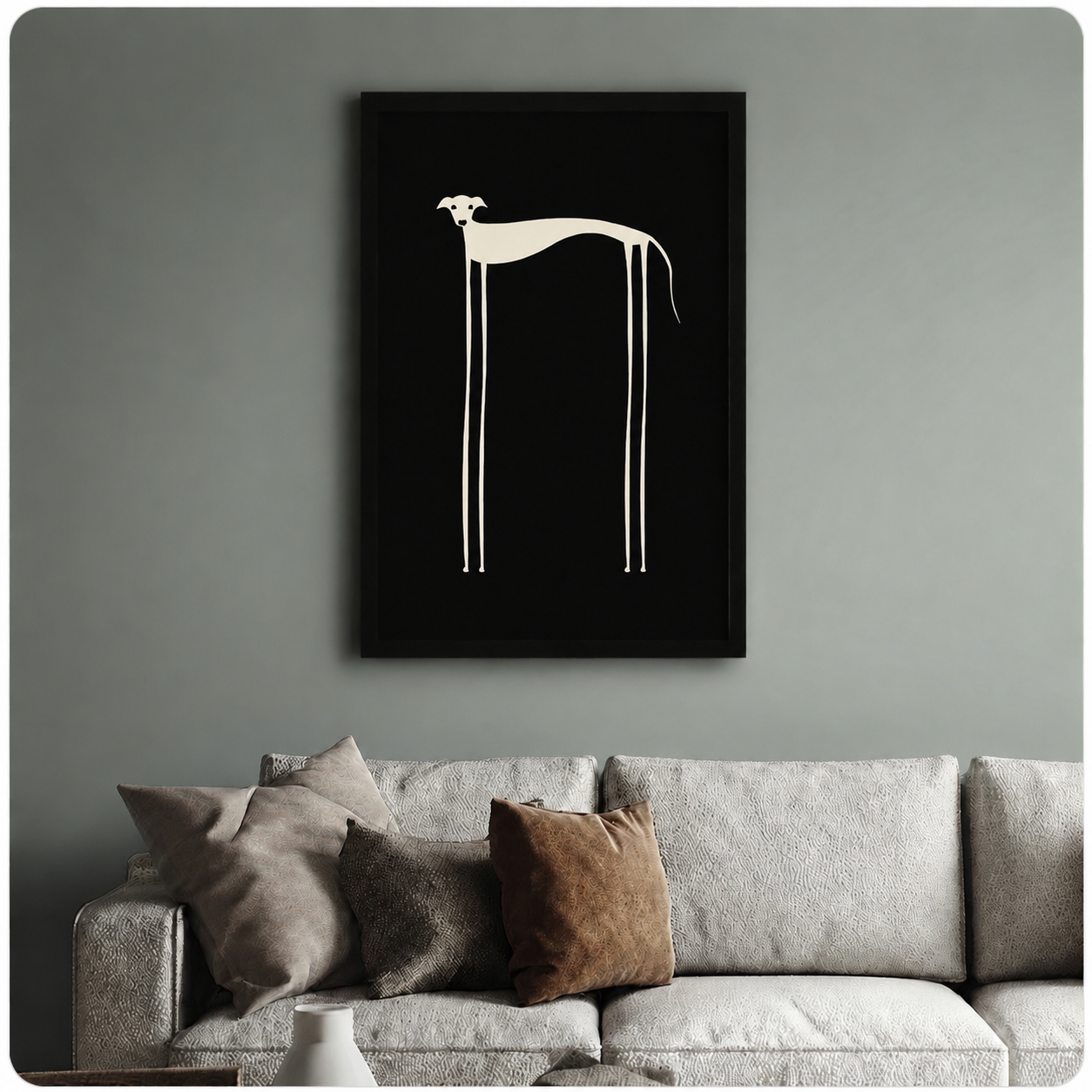 Black framed long-leg dog minimalist art print above neutral sofa on sage green wall