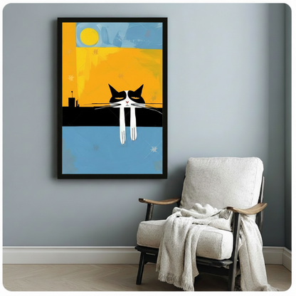 Black framed mid-century modern grumpy tuxedo cat on rooftop with sun canvas art showing a sullen black and white cat with half-closed eyes and long white dangling paws sitting on a flat black rooftop ledge beneath a vivid yellow sun on a bold split golden amber and sky blue geometric background with a small city silhouette, displayed beside a white linen folding chair with a cream throw