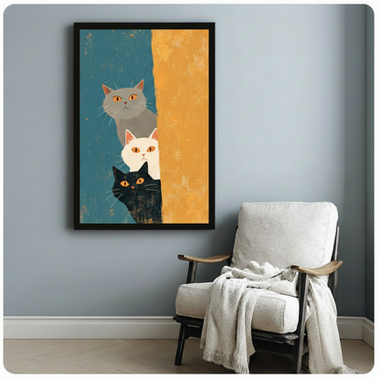 Black framed mid-century modern illustration trio of curious cats stacked vertically grey fluffy cat on top white cat in middle black cat at bottom all with glowing amber eyes peeking around large mustard yellow vertical stripe on aged teal background canvas print on pale blue-grey wall beside white linen lounge chair with draped cream throw - charming three peeking cats teal orange wall art for cozy reading nook decor