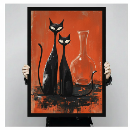 Person holding large framed mid-century modern oil painting two sleek black cats with white eyes sitting side by side beside clear glass vase on bold orange red brushstroke background canvas print with both hands - close up view of retro atomic age two black cats orange wall art with black frame finish