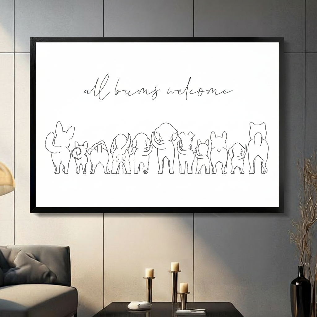Black framed minimalist all bums welcome line art canvas art with elegant script lettering above a row of over ten animal back view silhouettes including a rabbit, cat, dogs, elephant, pig, and French bulldog in single-stroke black line art on a clean white background, displayed on a dark gray tile wall above a gray sofa with candle holders and a black vase of dried flowers