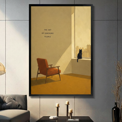 Black framed minimalist black cat sitting on windowsill canvas art with the art of ignoring people text and a retro orange armchair in warm golden tones, displayed on a dark gray wall above a console table with tall candlesticks beside a charcoal sofa
